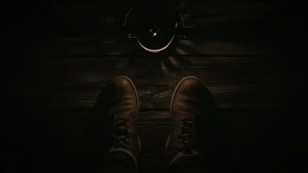 Person wearing sturdy closed-toe shoes on a wooden floor