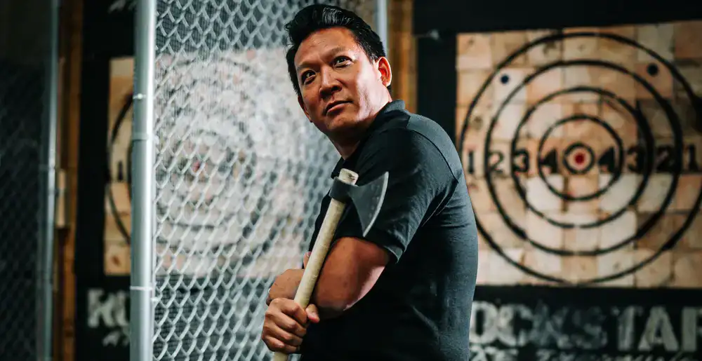 Colleagues cheering at an axe throwing lane