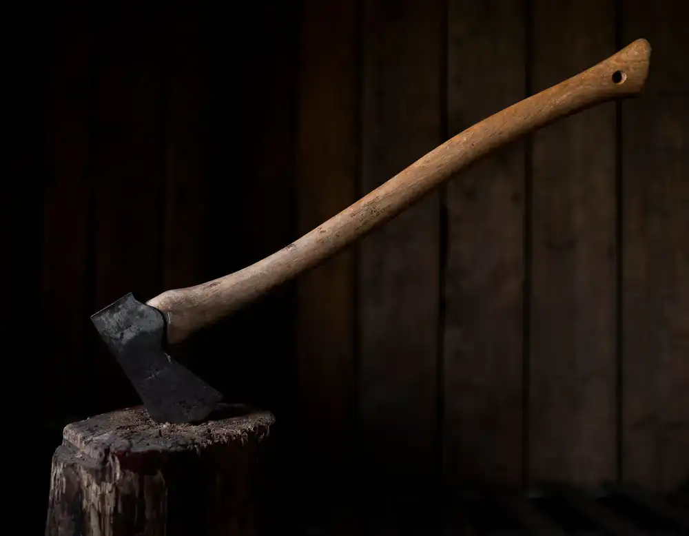 Close up of an axe embedded in a wooden target